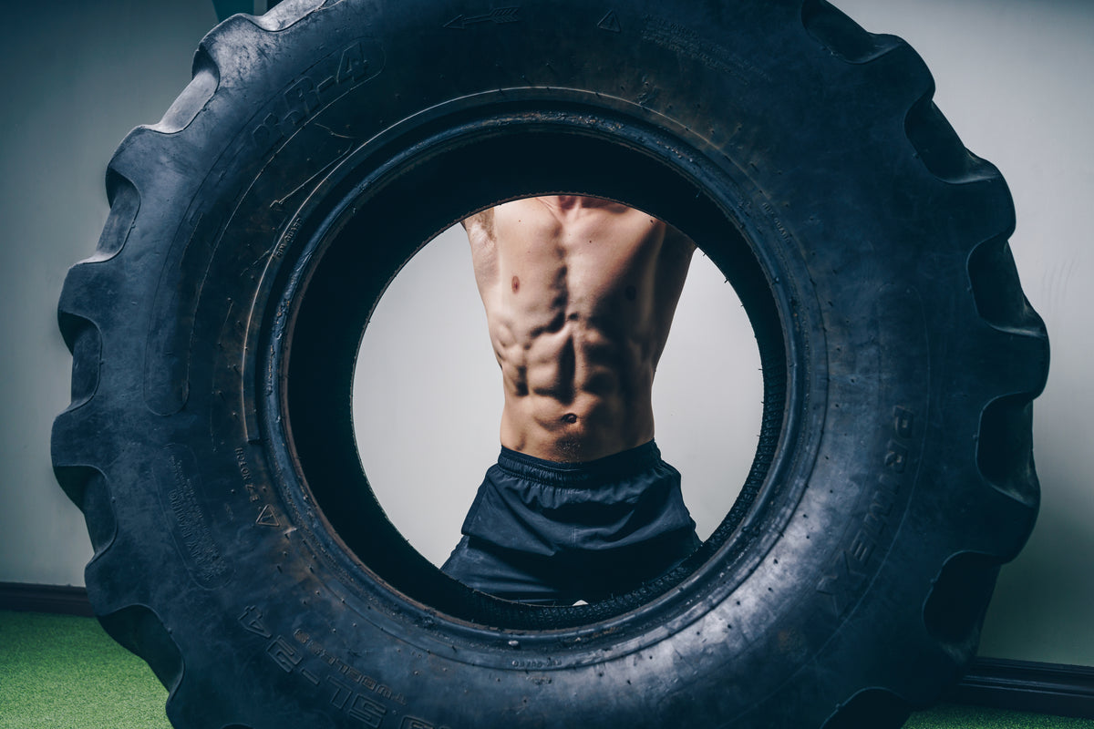Hyrox tyre flip training in STRYK gym wear - built for grit, power and resilience