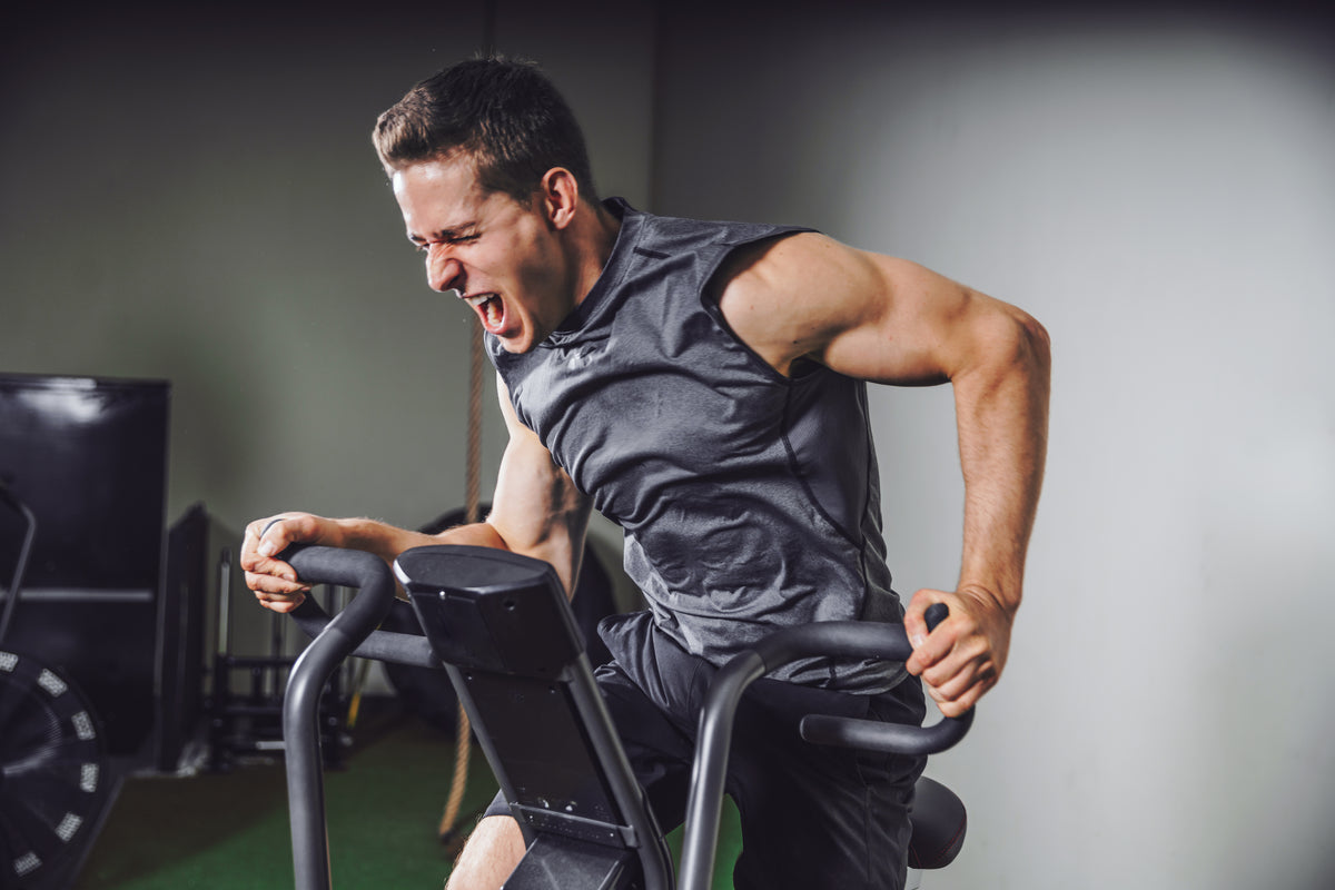 High-intensity assault bike workout featuring STRYK gym wear - apparel designed for athletes and warriors.