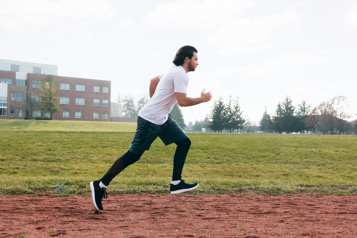 Runner training on track in STRYK apparel - built for distance and grit.